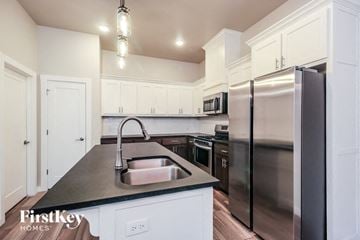 Yukon house for rent - A kitchen with a sink and a refrigerator.