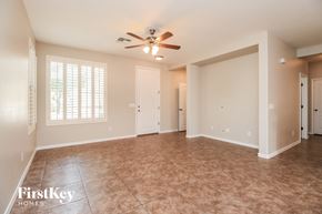 Gilbert house for rent - A spacious room with a ceiling fan and tiled floor.