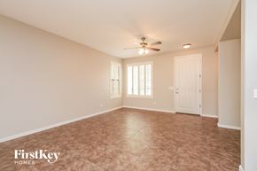 Gilbert house for rent - A spacious room with a ceiling fan and tiled floor.