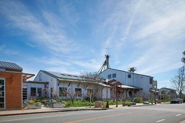 Morgan Hill apartment for rent - A building with a grey roof and a white wall with a red awning.