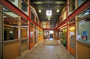 Morgan Hill apartment for rent - A long hallway with a carpeted floor and glass walls on both sides.