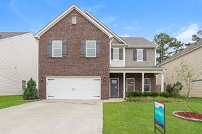 Calera house for rent - A two-story brick house with a white garage door.