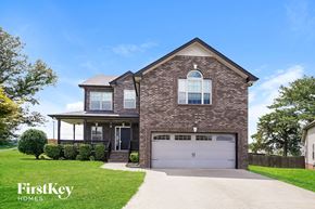 Clarksville house for rent - A brick house with a garage door and a driveway.