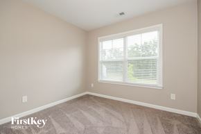 Powder Springs house for rent - a bedroom with a window and a carpeted floor