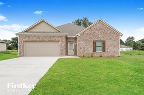 Jasper house for rent - a brick house with a garage and a green lawn