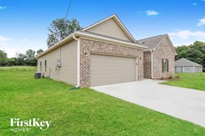 Jasper house for rent - a brick house with a garage and a driveway