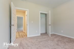 Jasper house for rent - a master bedroom with two closets and a carpeted floor