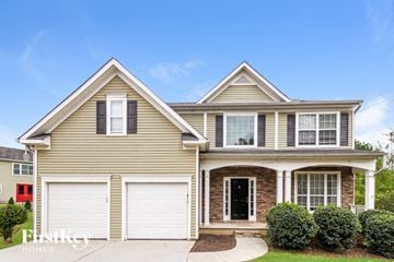 Canton house for rent - a beige house with white garage doors