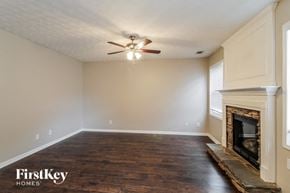 Canton house for rent - a living room with a fireplace and a ceiling fan