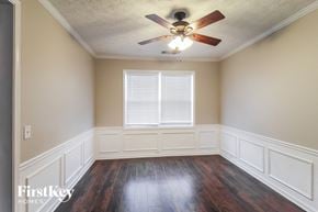 Canton house for rent - an empty room with a ceiling fan and a window