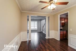 Canton house for rent - an empty living room with wood floors and a ceiling fan
