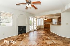 Tucson house for rent - a kitchen and living room with tile flooring and a ceiling fan