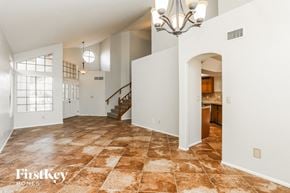 Tucson house for rent - a living room with a staircase and a tile floor