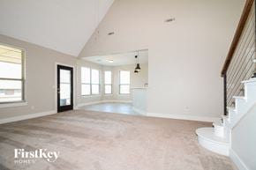 Yukon house for rent - an empty living room with white walls and a white staircase