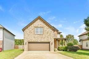 Clarksville house for rent - A house with a garage door and a window is shown.