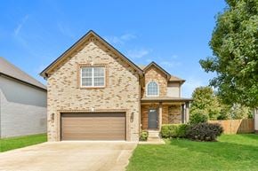Clarksville house for rent - A house with a garage door and a window.