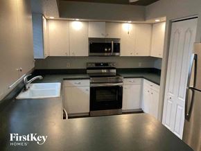 Venice house for rent - A kitchen with a stove top oven and a microwave above it.