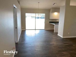 Venice house for rent - A room with wooden flooring and a sliding glass door leading to a balcony.