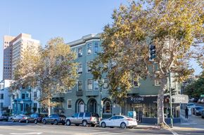 Oakland apartment for rent - A street view of a city with cars parked on the side of the road.