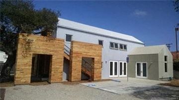 Arroyo Grande apartment for rent - A white building with a grey addition and a brown door.