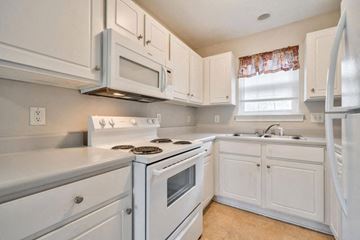 Durham apartment for rent - a white kitchen with white cabinets and white appliances