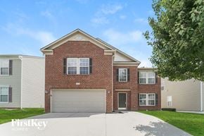 Charlotte house for rent - A brick house with a garage door is for sale.
