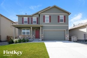 Lochbuie house for rent - a beige house with red shutters and a driveway
