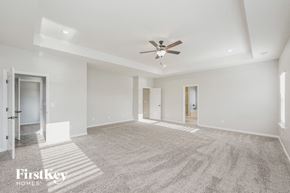 Murfreesboro house for rent - an empty living room with a ceiling fan and white walls