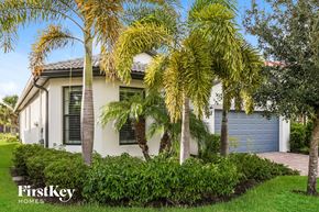 Alva house for rent - a house with palm trees in front of it