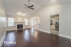 Locust house for rent - an empty living room with a fireplace and a ceiling fan