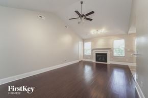 Locust house for rent - an empty living room with a ceiling fan and a fireplace