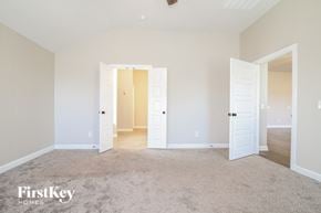 Yukon house for rent - a bedroom with two doors and a carpeted floor