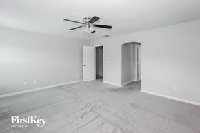 Locust house for rent - a empty living room with a ceiling fan and white walls