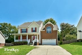 Clarksville house for rent - a large brick house with a white garage door