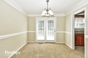 Clarksville house for rent - an empty dining room doors and a chandelier