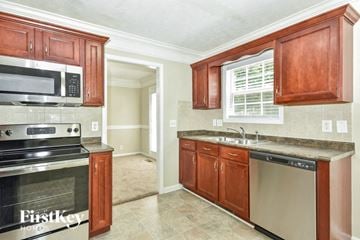 Clarksville house for rent - a kitchen with a stove and a sink and a microwave