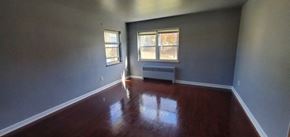 Cincinnati apartment for rent - an empty living room with wooden floors and a window