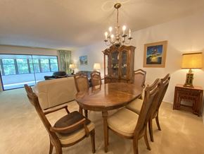 Bradenton house for rent - a dining room with a table and chairs and a couch