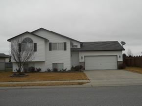 Post Falls apartment for rent - a white house with a white garage door