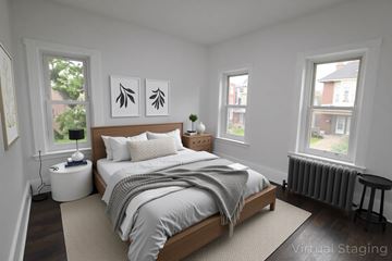 Chester apartment for rent - A bedroom with a bed, nightstand, and two windows.