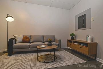 Chester apartment for rent - A living room with a grey couch, a coffee table, and a side table with a plant on it.