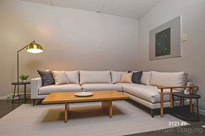 Chester apartment for rent - A modern living room with a white couch, a wooden coffee table, and a lamp.