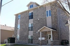 Oshawa apartment for rent - A large brick building with a small porch and a covered entrance.