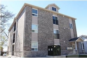 Oshawa apartment for rent - A modern building with a mix of stone and siding exterior.