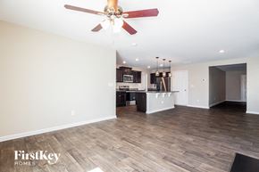 Dallas house for rent - A room with a ceiling fan and wooden flooring.