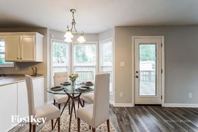 Clarksville house for rent - A dining room with a glass table and chairs.