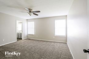 Galloway house for rent - a bedroom with a ceiling fan and a carpeted floor