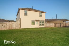 Katy house for rent - A house with a fence and a grassy yard.