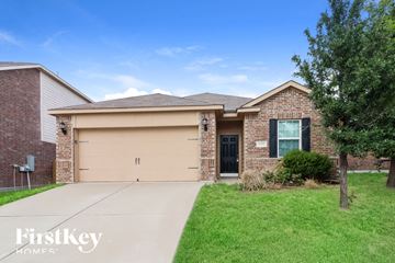 Fort Worth house for rent - a brick house with a garage and a driveway