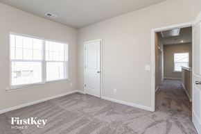 Adairsville house for rent - a bedroom with a hallway and a door and a window